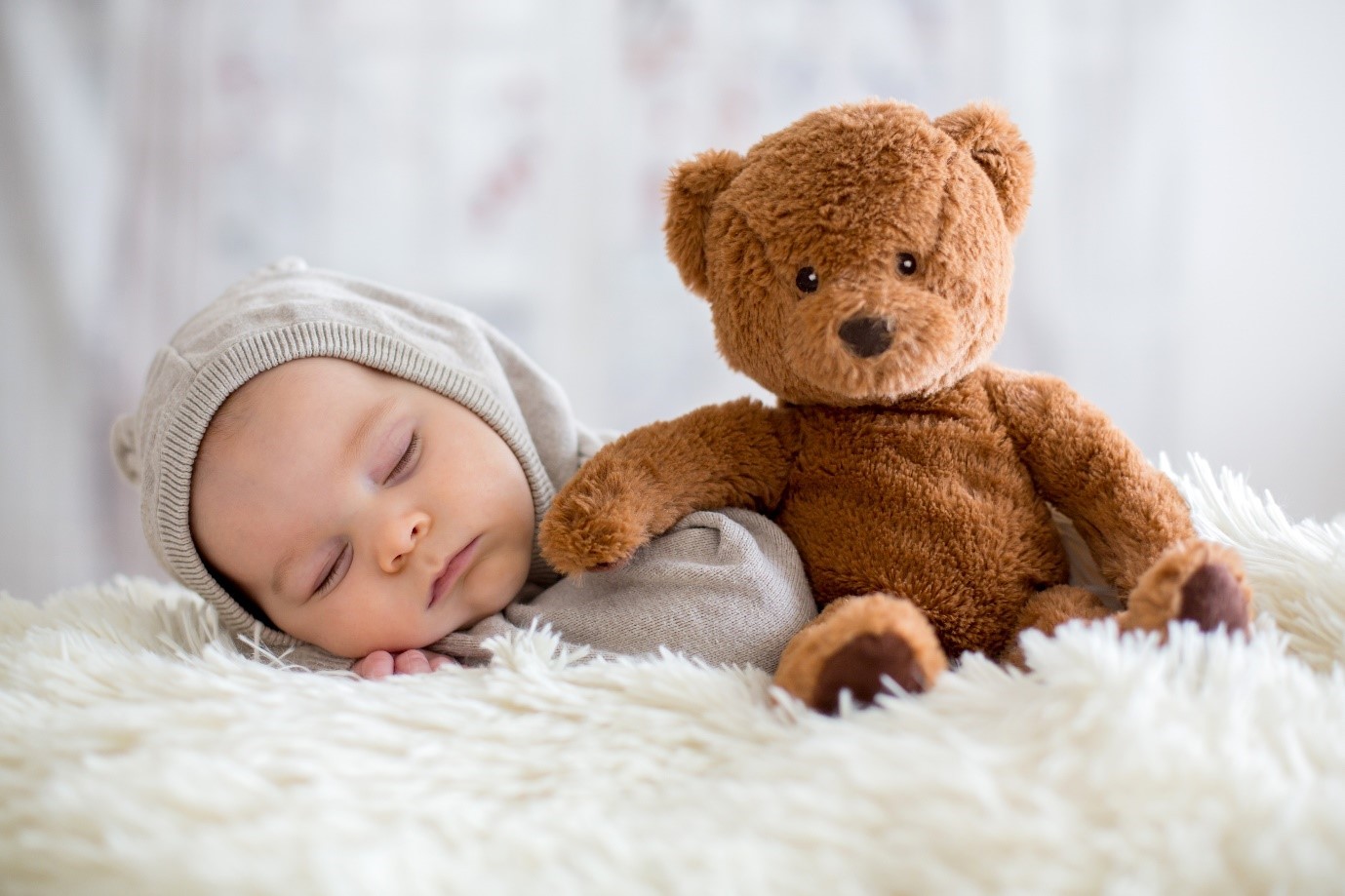 Sleeping baby with teddy bear