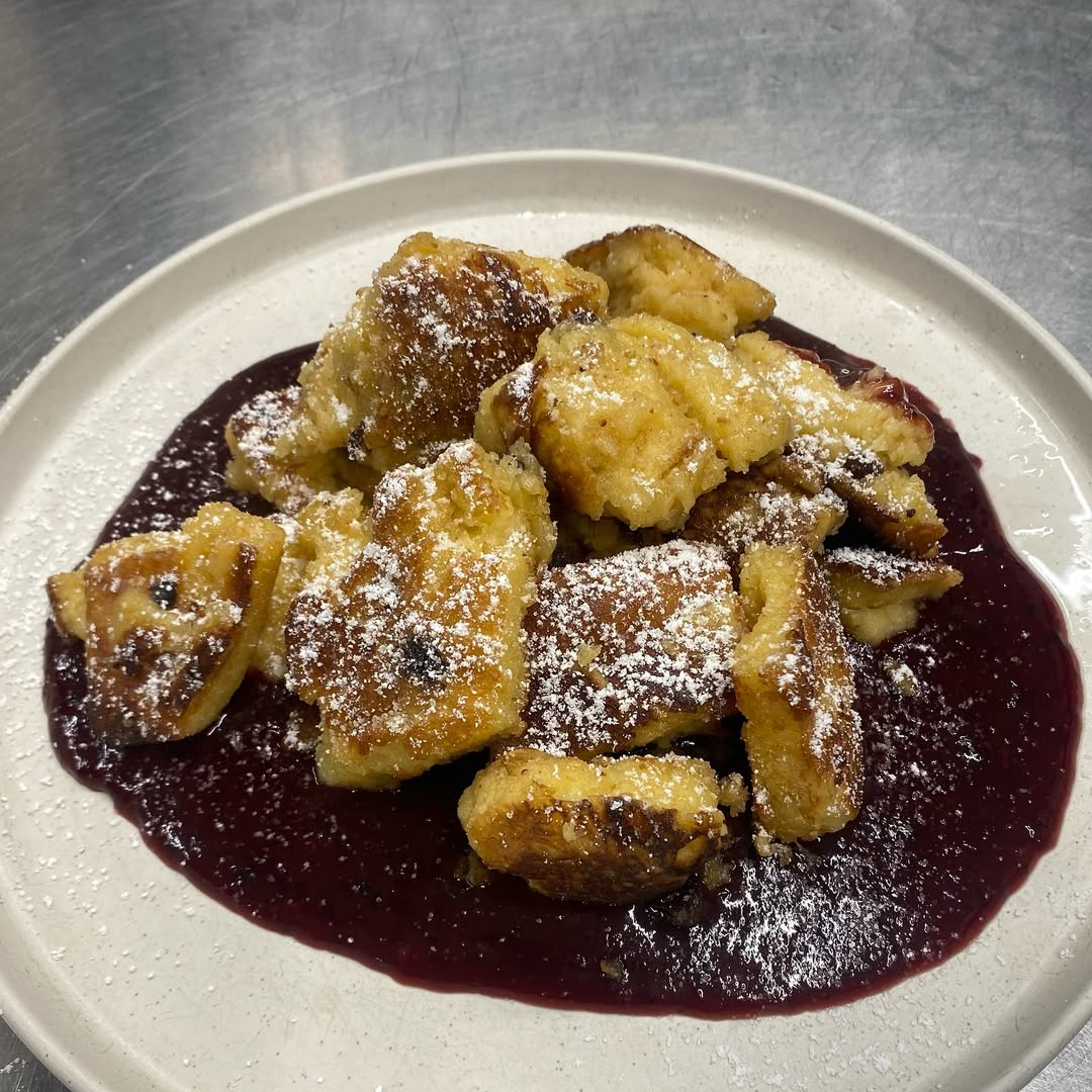 an interior of a fine dining restaurant with focused shot on the table with the plates and glass has been served