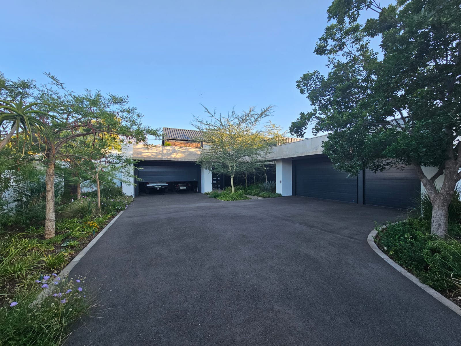 Close-up of a sleek silver sports car front with alloy wheel under dramatic studio lighting.
