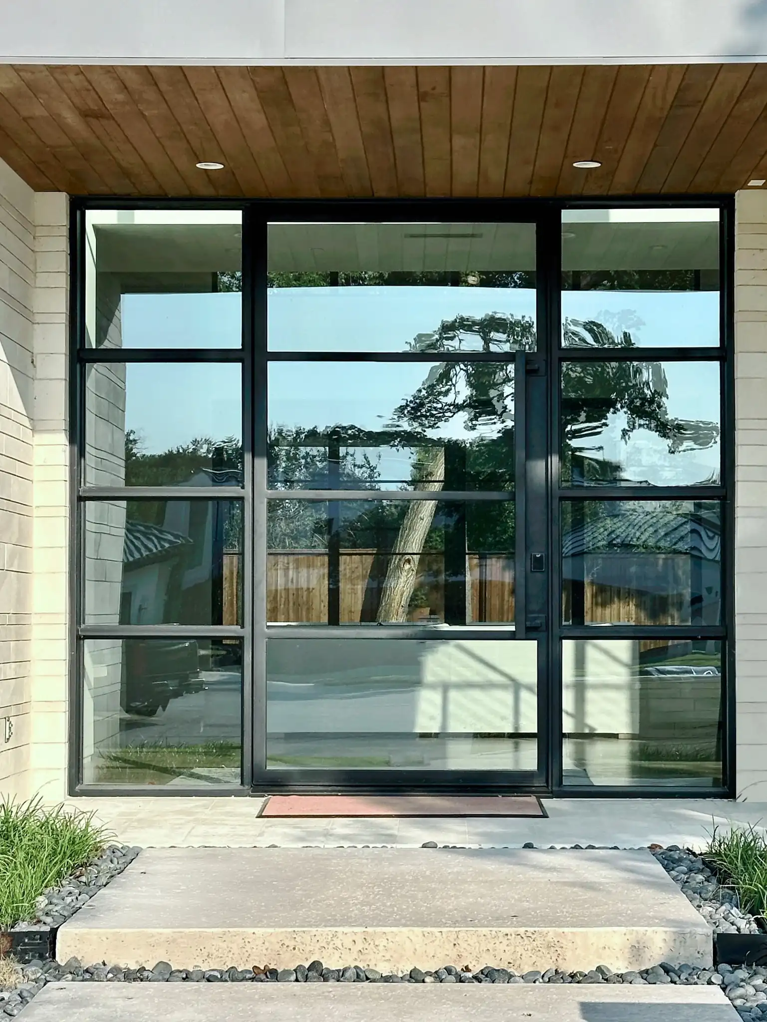 Modern pivot door with 8 side lites on a Southlake home