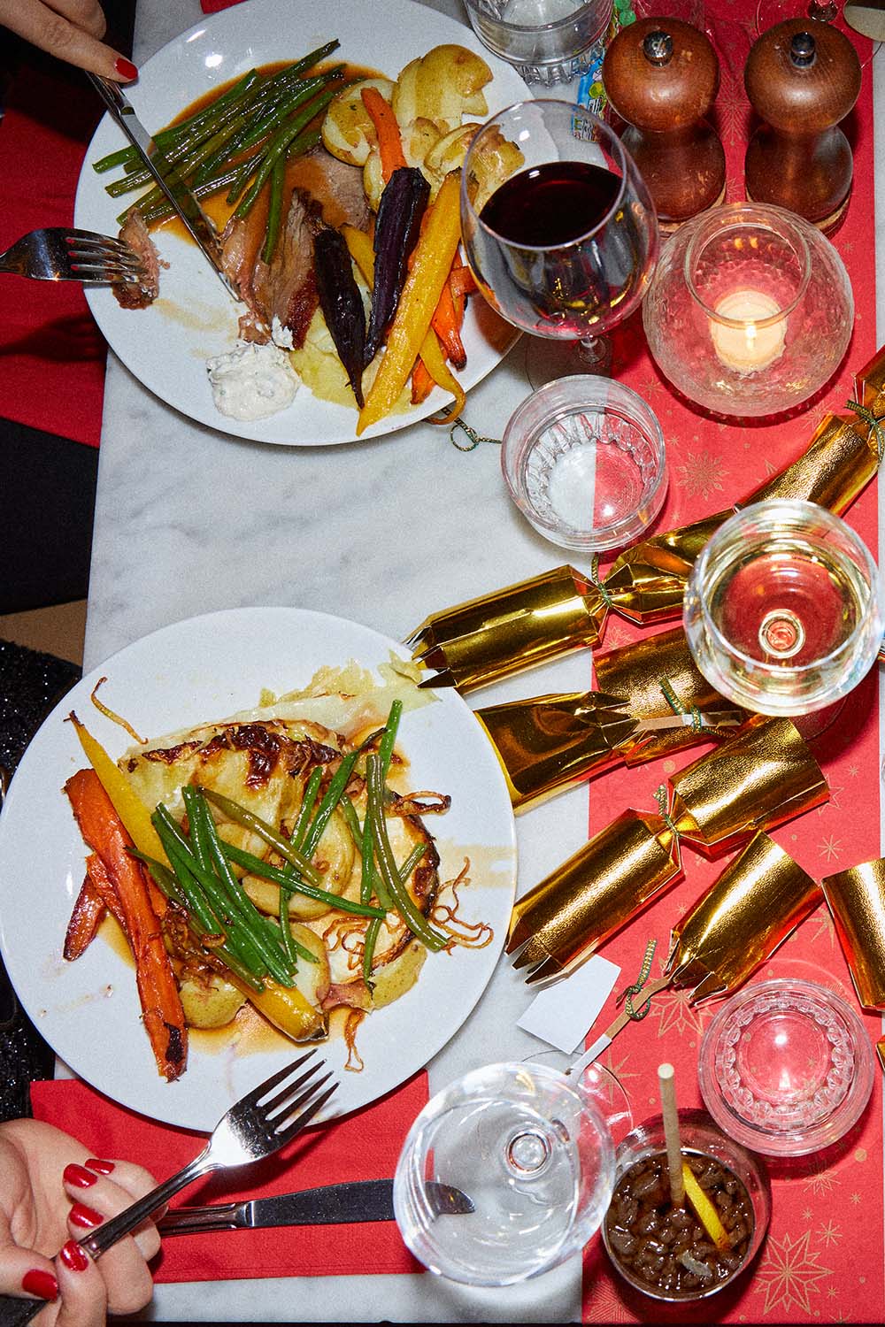 People serving food onto their plate from a buffet