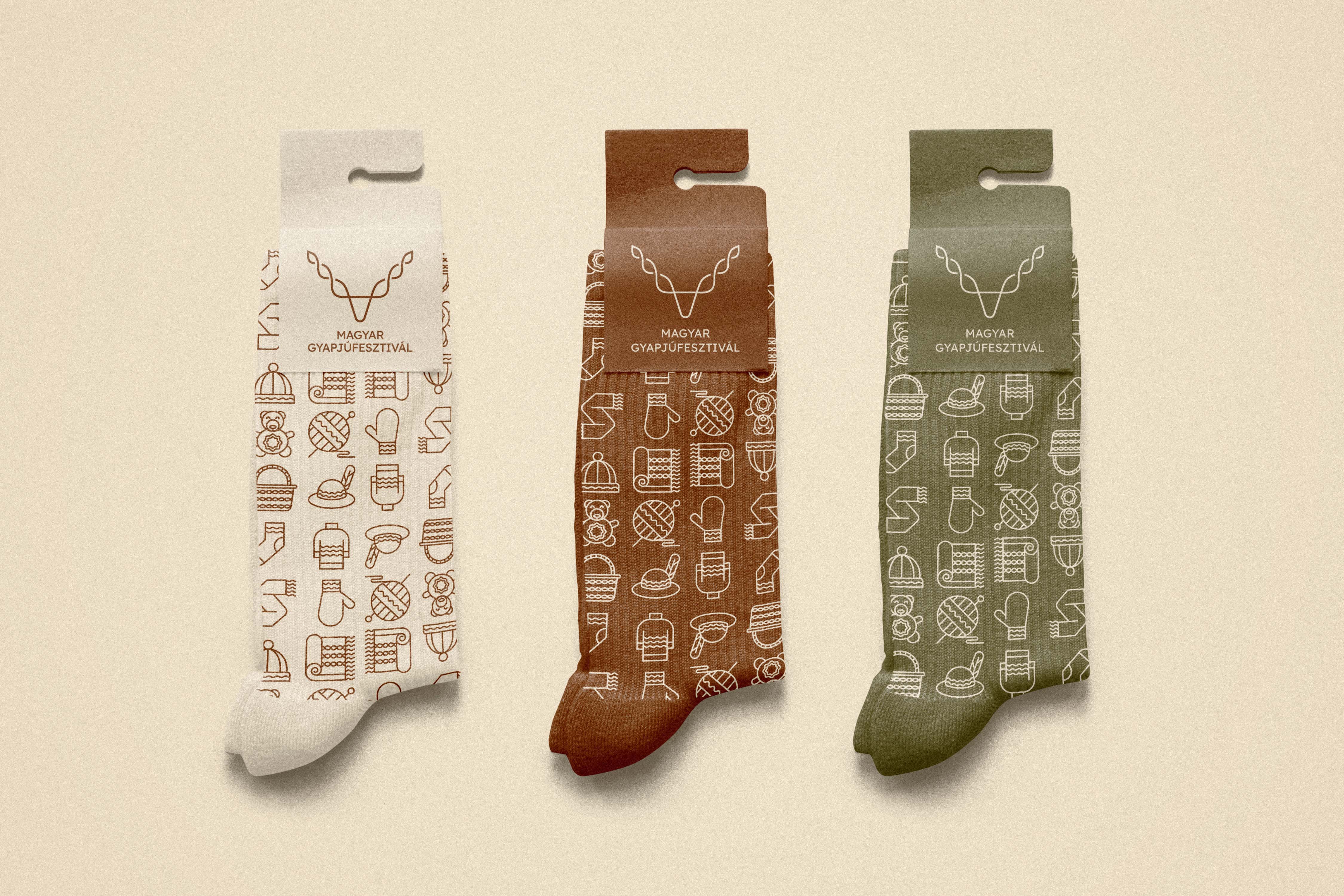 Three pairs of socks in beige, brown, and green featuring custom festival iconography - Hungarian Wool Festival, a festival brand identity.
