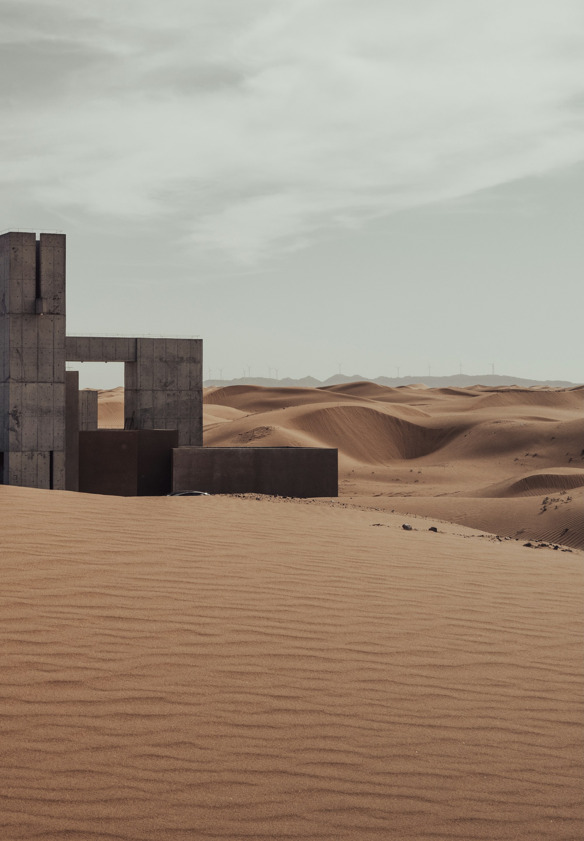 Concrete shapes among desert dunes