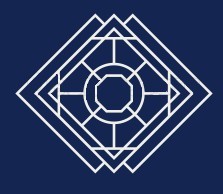 Smiling young woman with curly hair sitting at a laptop, in front of a teal wall.