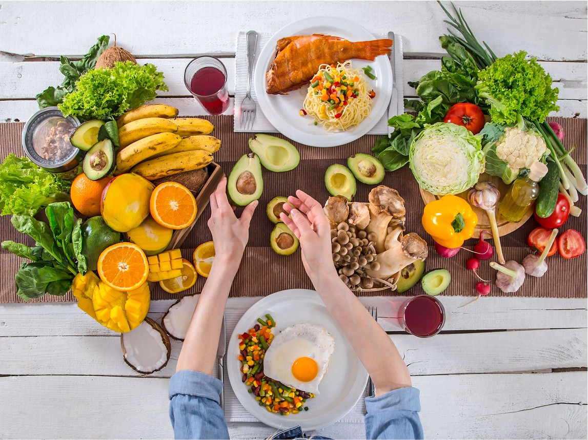 The woman at the dinner table with organic food