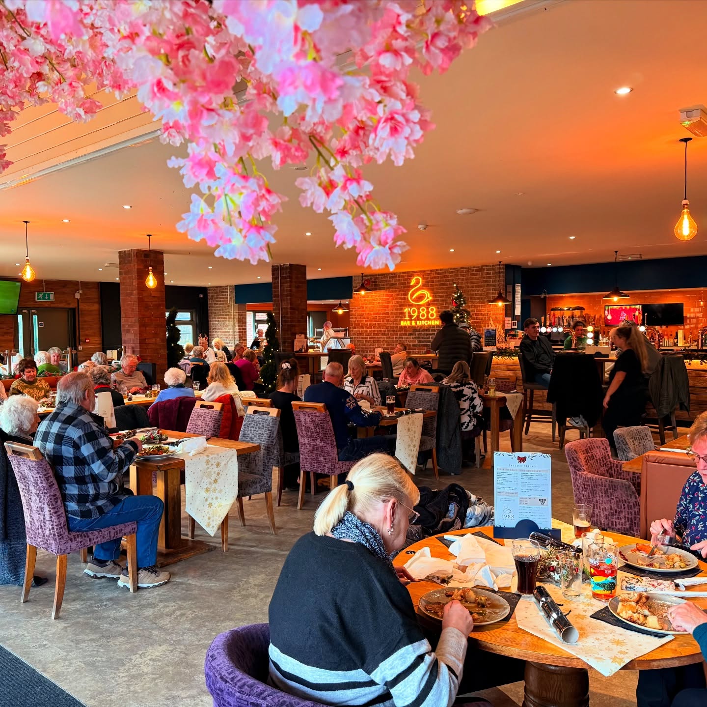 A full restaurant of diners eating Christmas dinner