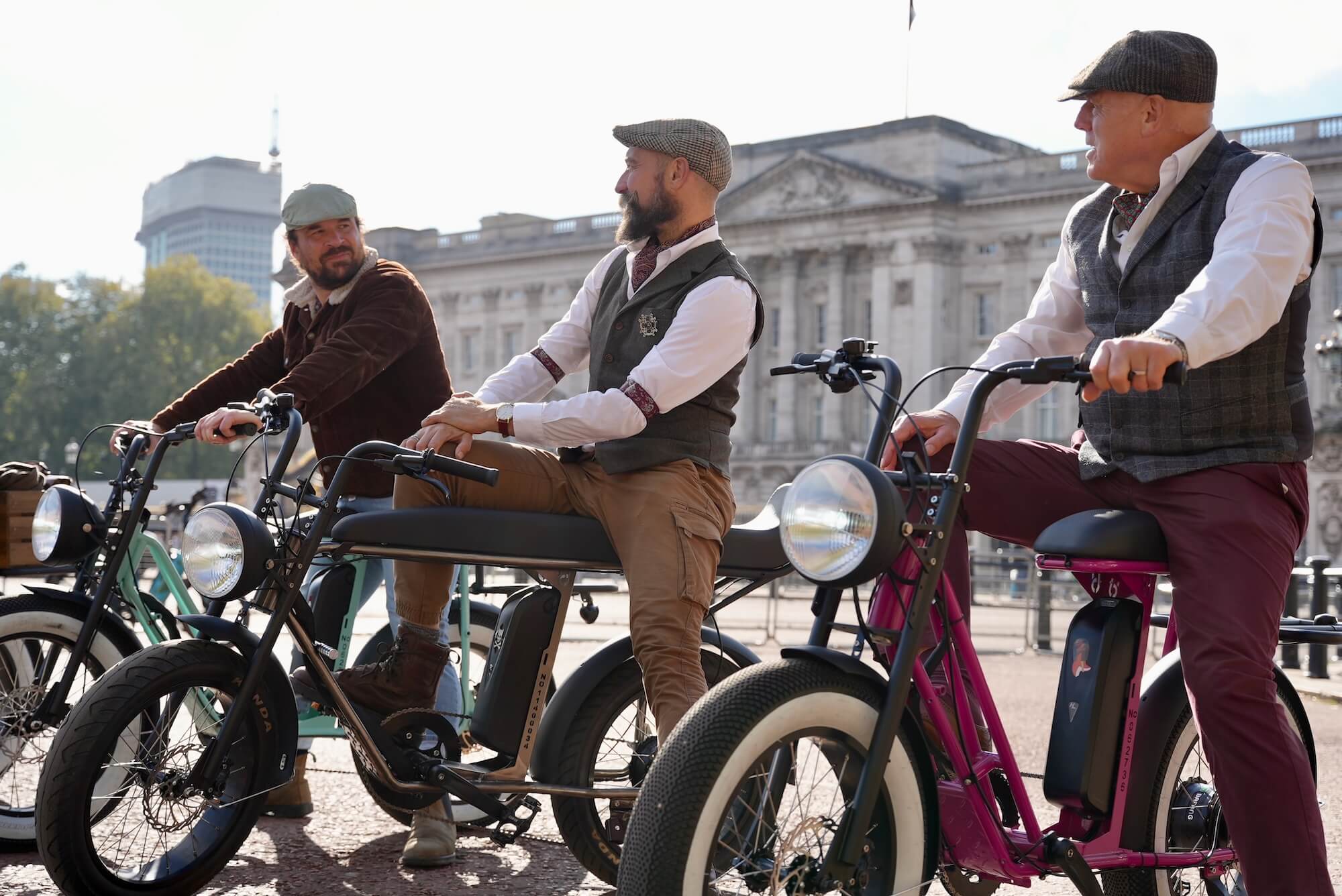 A group of Tally Ho guides in front of Buckingham Palace on retro e-bikes 