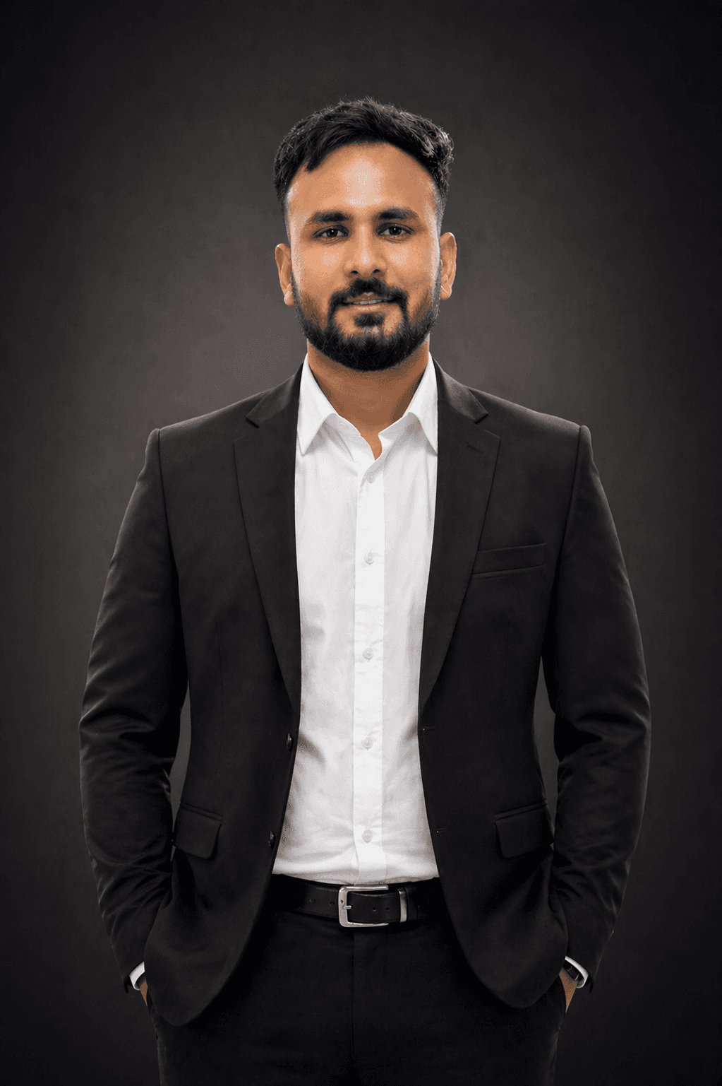 Professional portrait of Rankawat Group Jaipur team member in formal black suit and white shirt, confident corporate profile headshot for real estate company website.