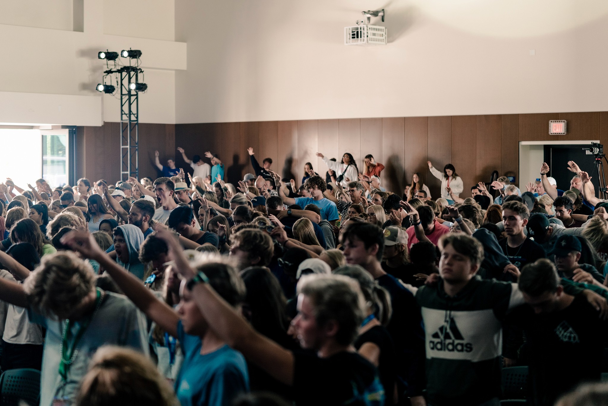 two people in a workspace working on their laptops