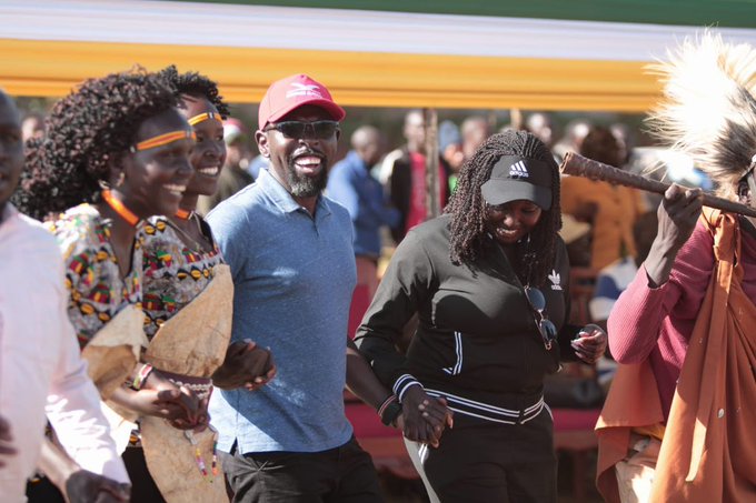 Tim Kipchumba dancing with community members in traditional Marakwet dress at a county gathering