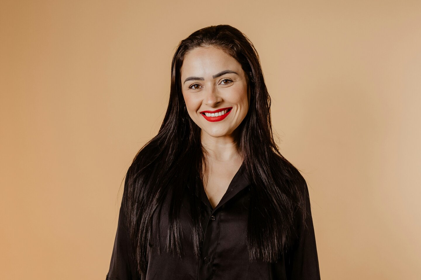 a woman in a black shirt is posing for a picture