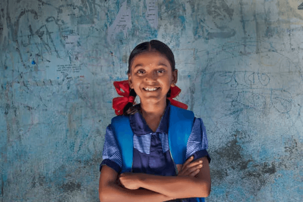 School student smiling, representing confidence and access to learning opportunities