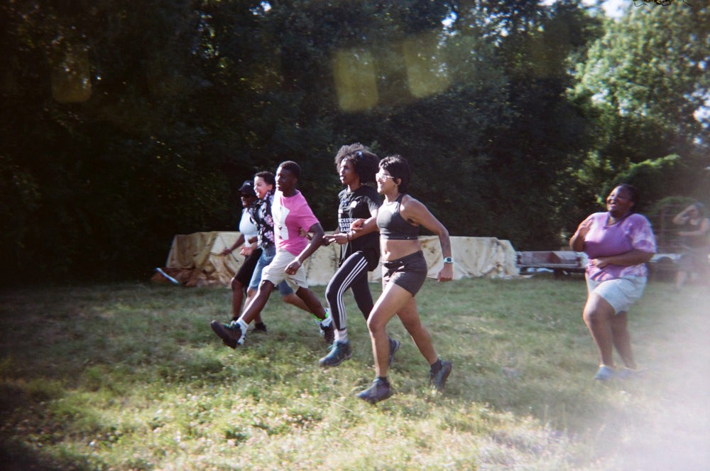 A group of people taking part in a three legged race