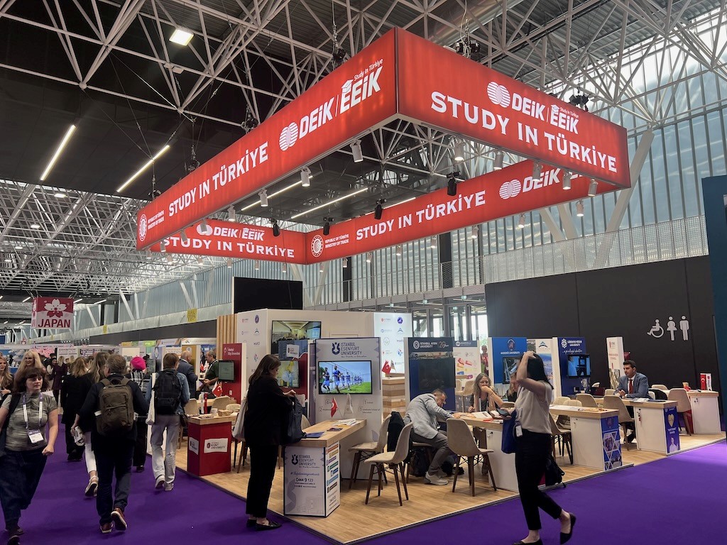 DEİK Study in Türkiye country pavilion at EAIE Toulouse 2024, featuring a large logo wall with 'DEIK' and 'STUDY IN TÜRKIYE' branding.
