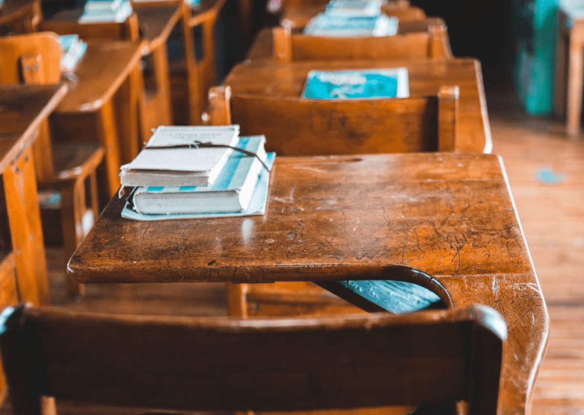 A chair and table with books on it.