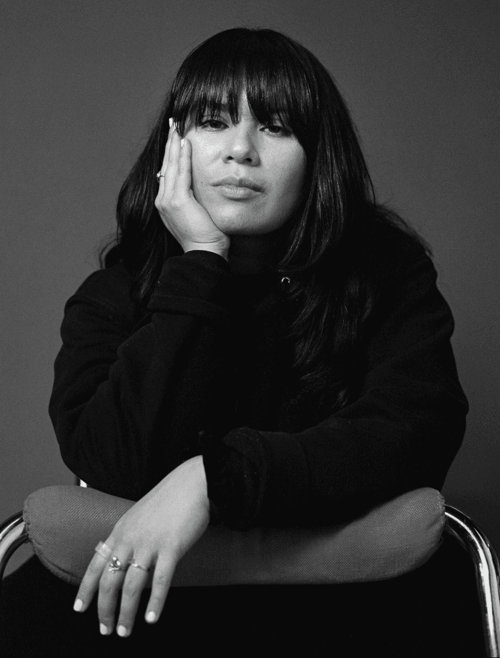 Portrait of Camila Ruiz Lora leaning over the back of a chair