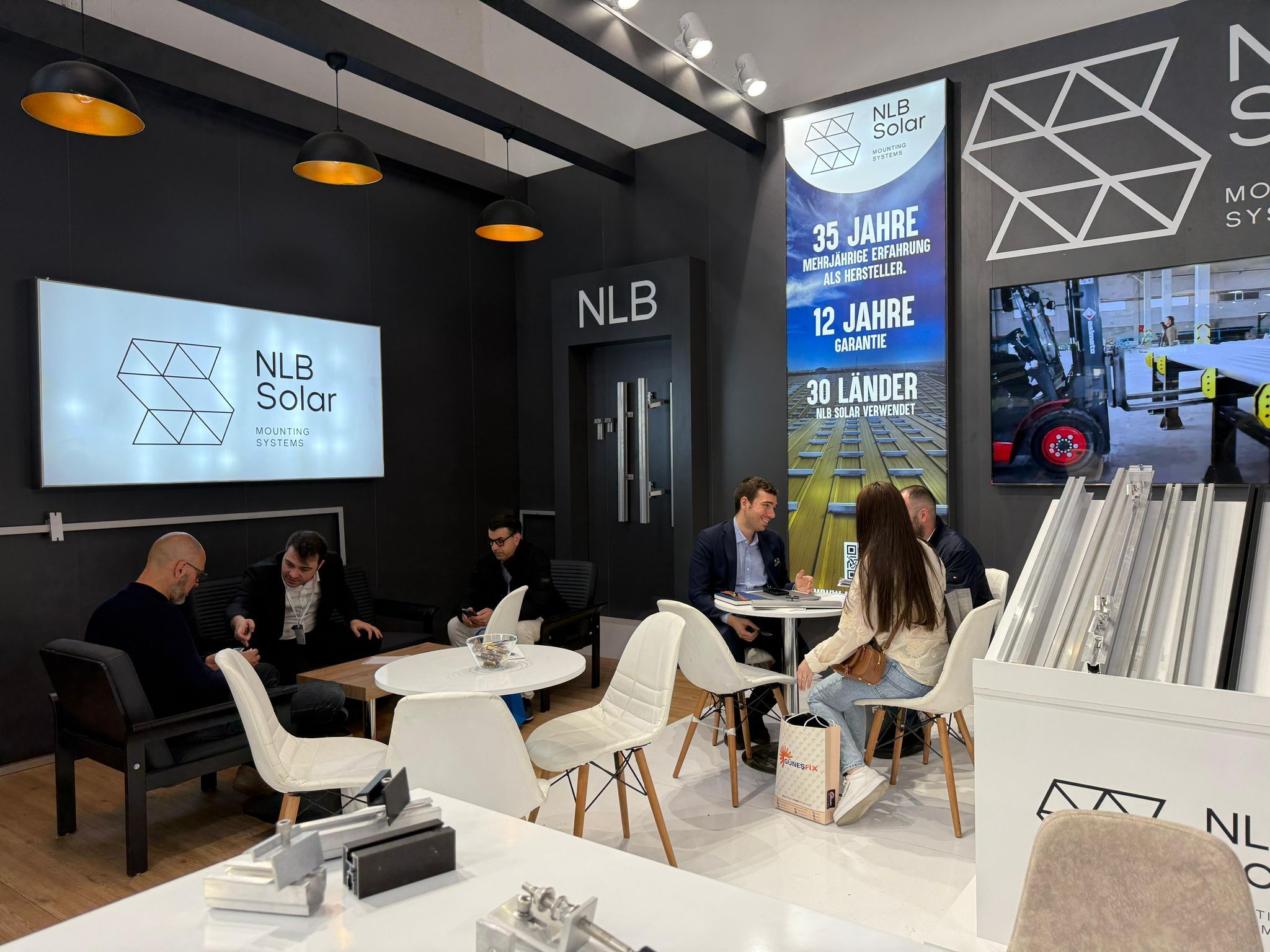 Lounge-style seating and open meeting area at the NLB Solar stand, designed for client consultations and technical discussions.