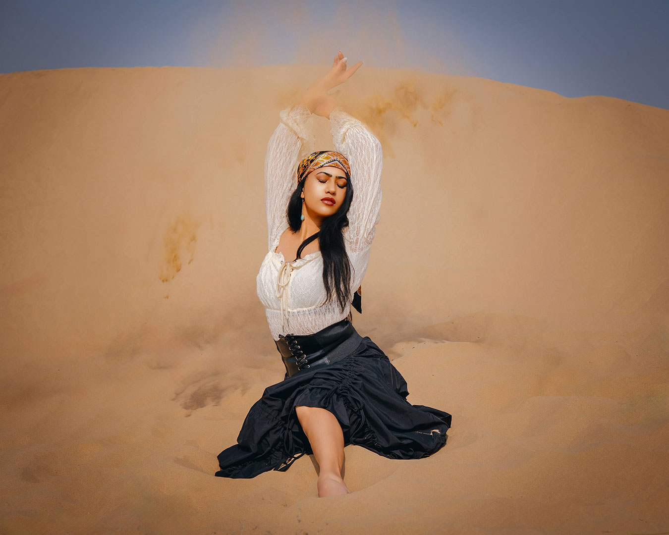 Desert photoshoot showcasing flowing outfits and scenic sand landscapes