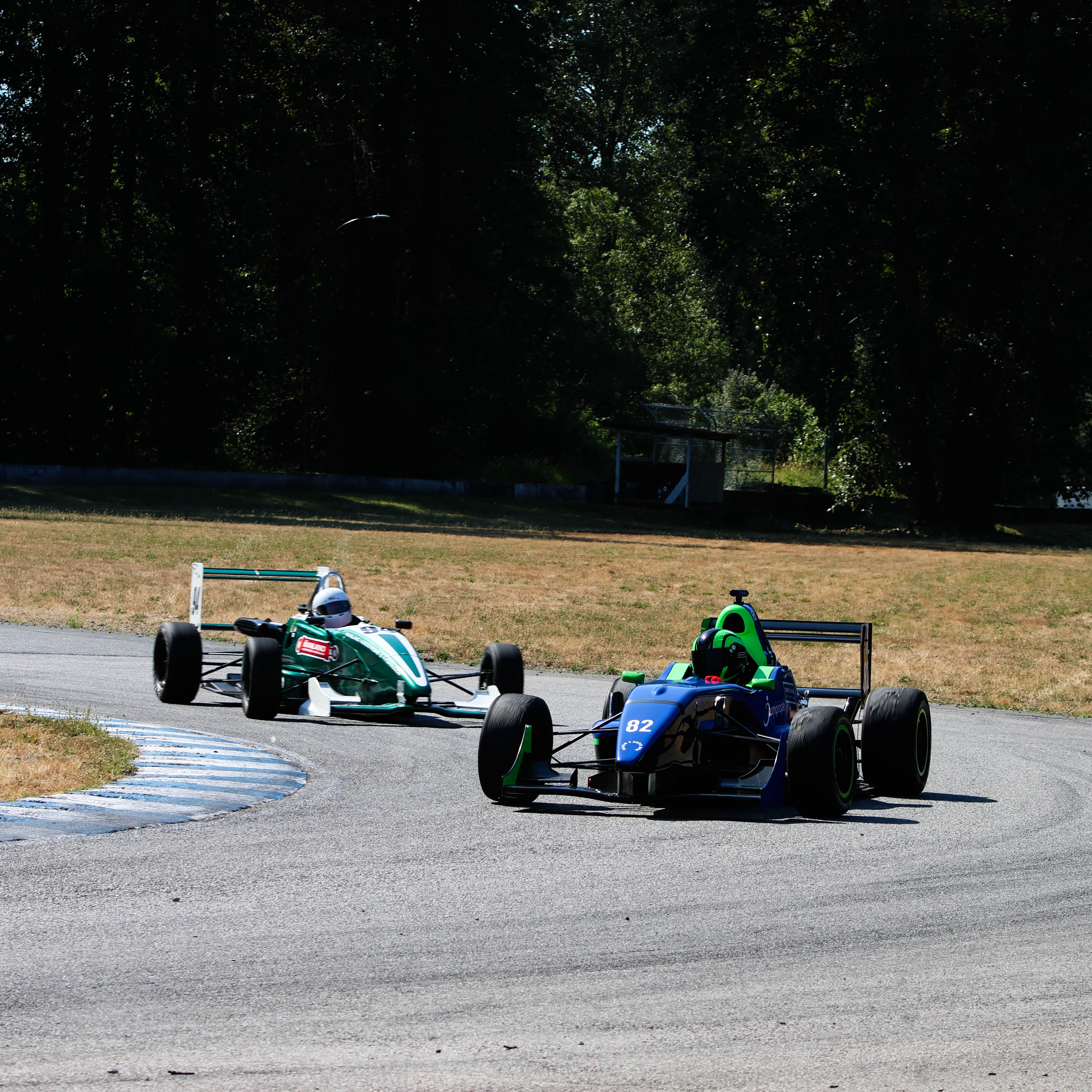 Film clapperboard in focus with glowing orange background, misty street, and silhouettes of people and lights; conveys mystery and anticipation.