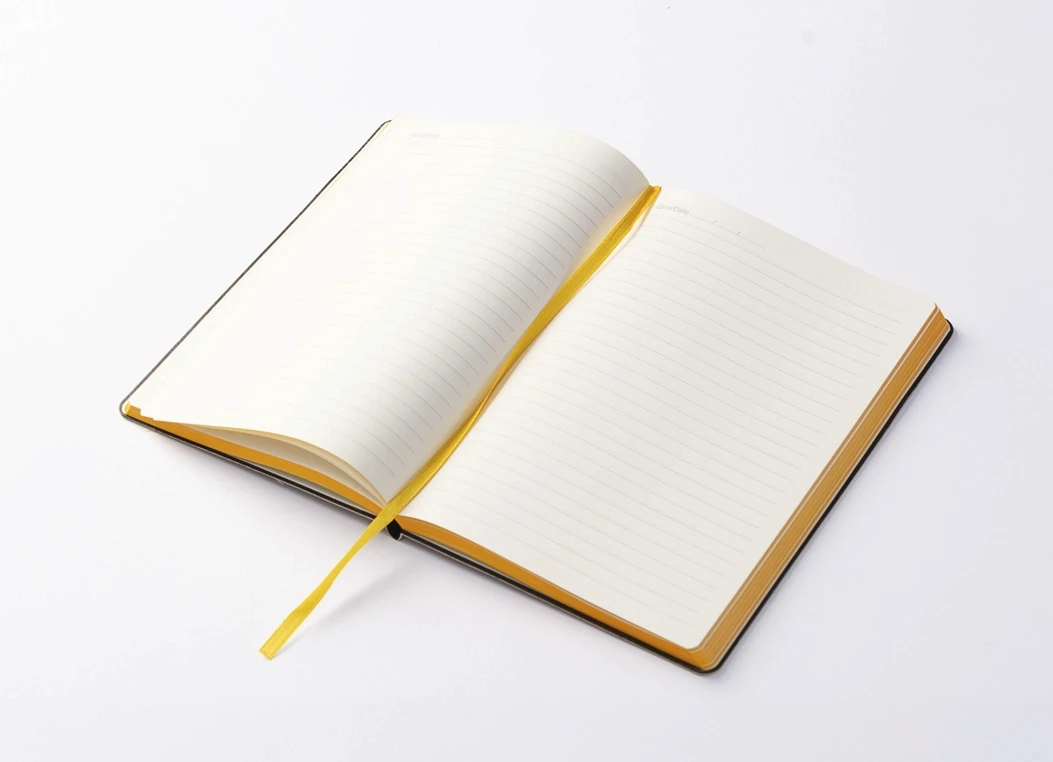 Open two-tone journal with ruled ivory pages and yellow ribbon bookmark