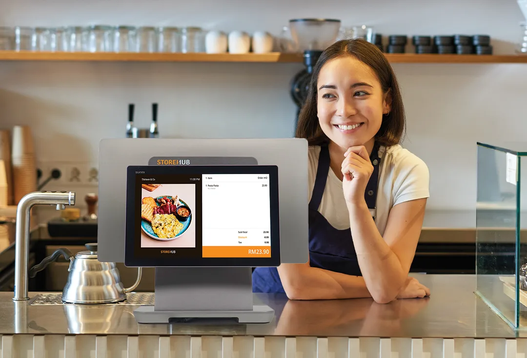 Malaysian F&B business owner using the StoreHub cloud-based POS system for inventory management, sales reporting, and order tracking.