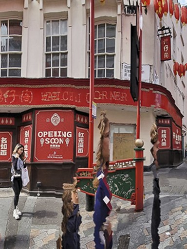 Panoramic photograph of a Chinatown street lined with red lanterns and traditional architecture. Pedestrians walk through the distorted scene, their figures elongated and fragmented, blending everyday movement with rhythmic visual abstraction.