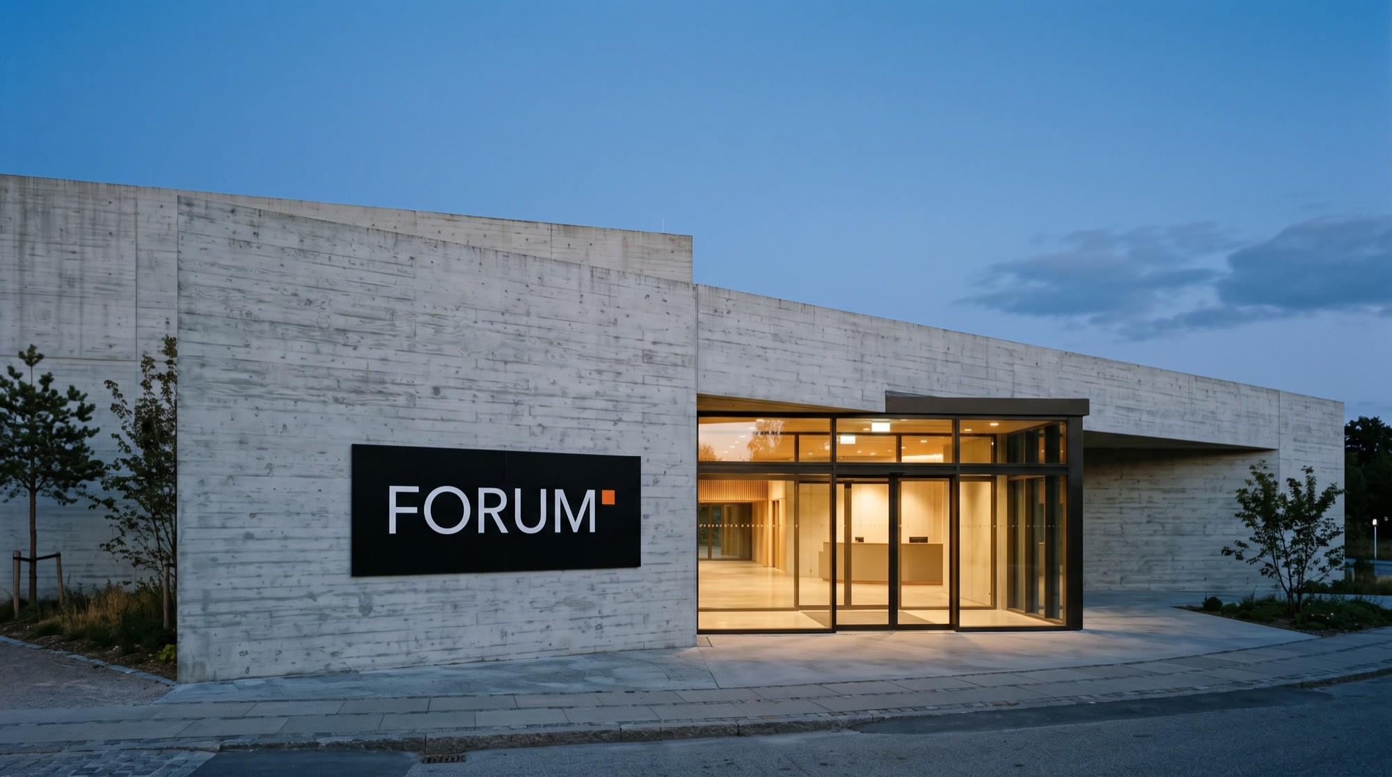 Forum Cultural concrete building at dusk with its illuminated sign above the entrance