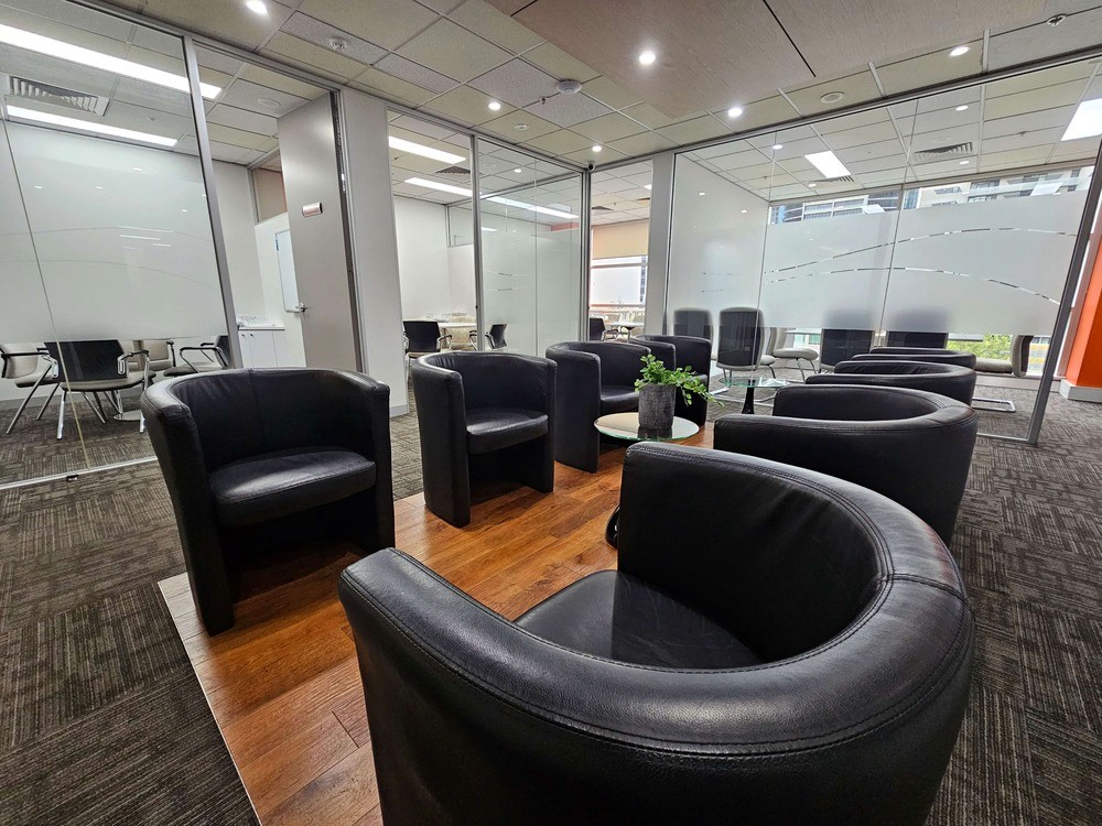 The waiting area for a mediation room provider, featuring the outside view of four mediation rooms and six seats in the waiting space.