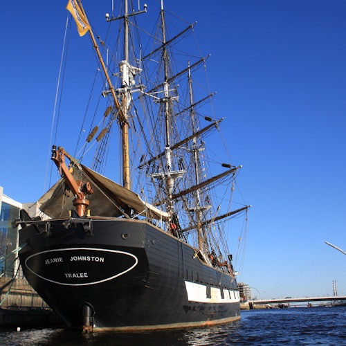 The stern of the Jeanie Johnston famine ship on the River Liffey, with the Samuel Beckett bridge in the background