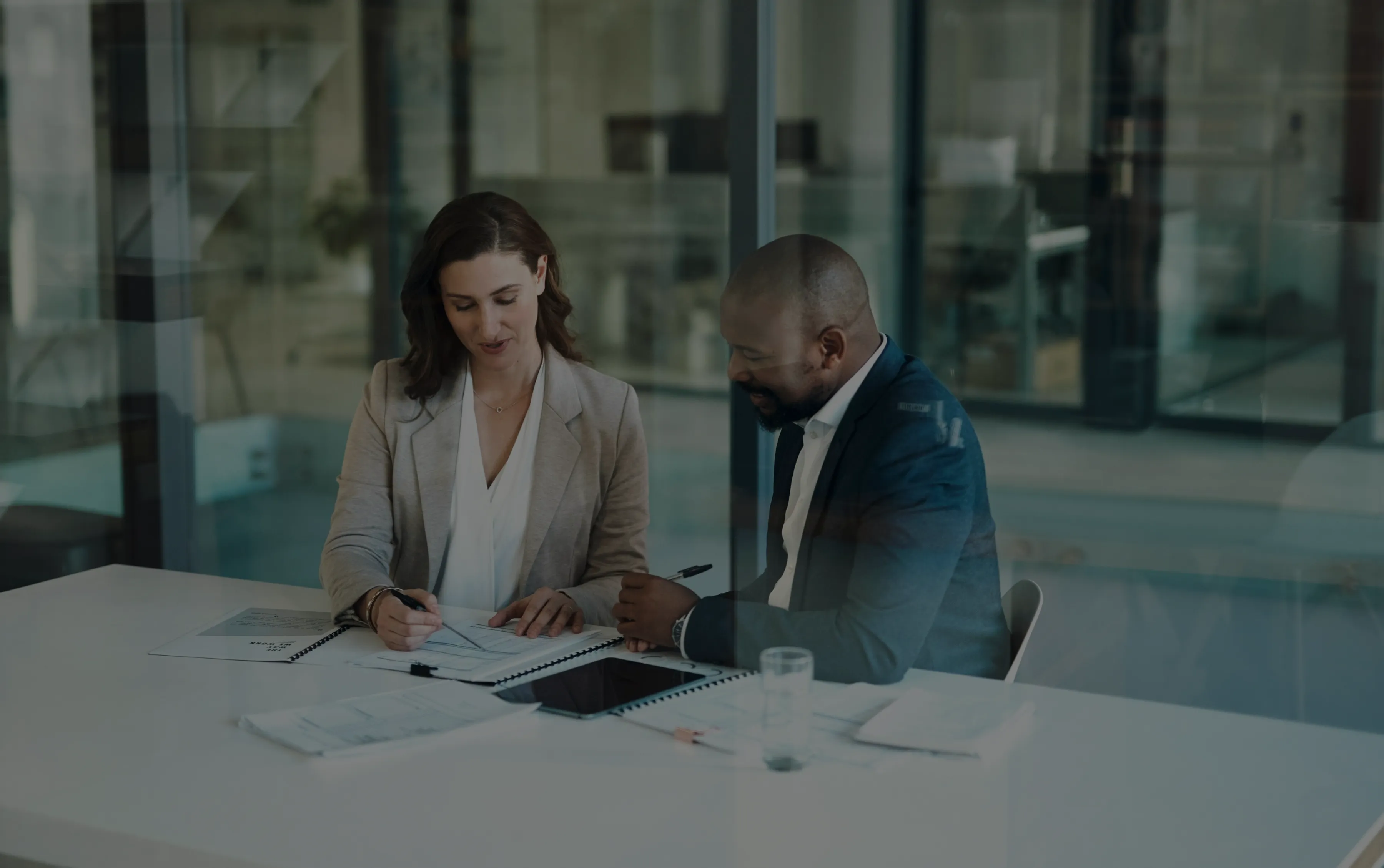 a man and a woman discussing in an office