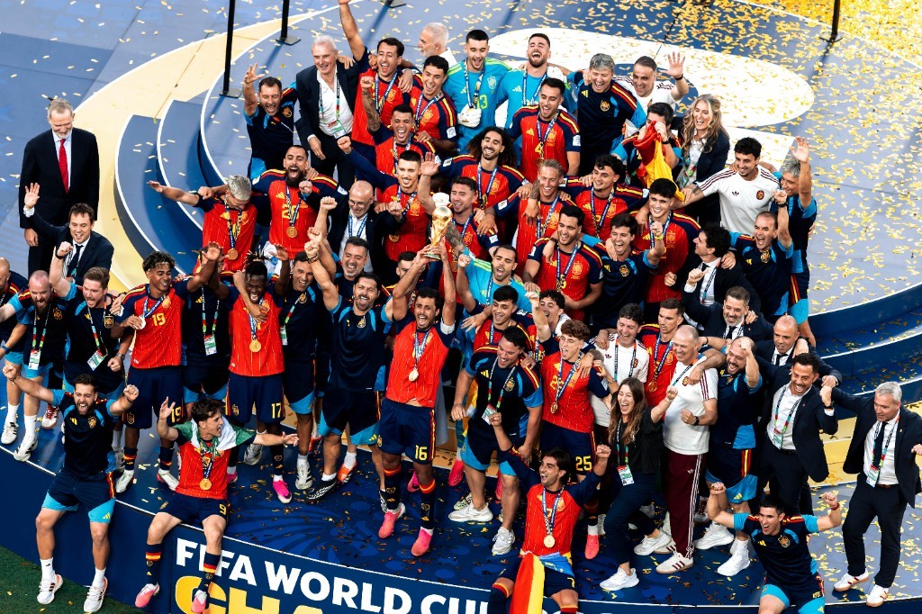 Spain players lift the FIFA World Cup trophy on the champions podium after beating Argentina in the 2026 final