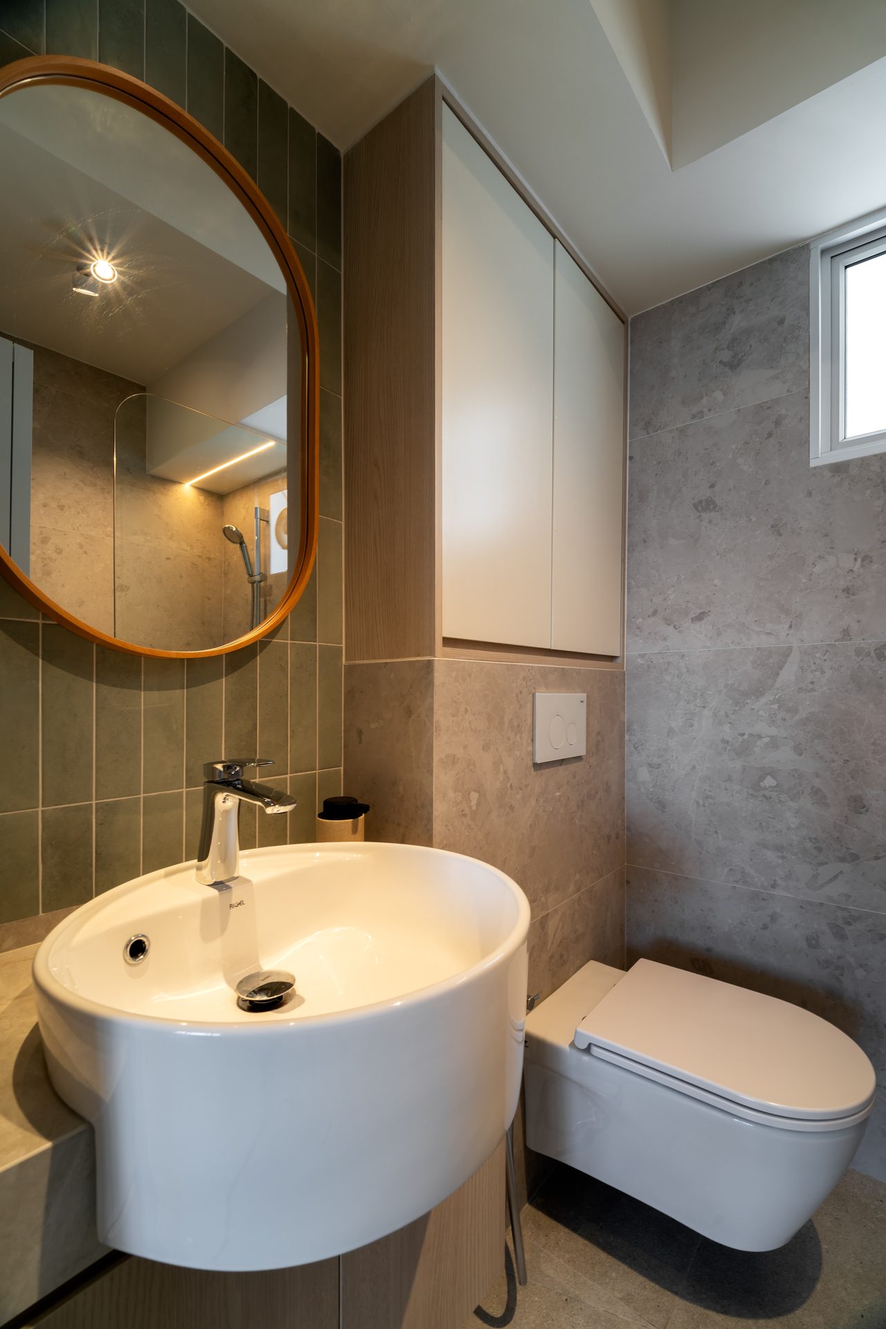 Green kitkat tiles on feature wall complimenting grey tiles on walls and floor