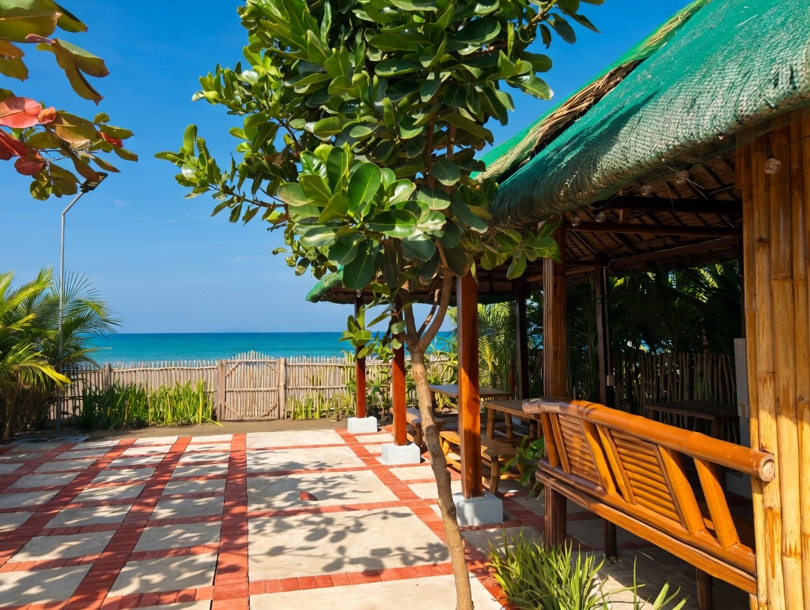 Beachside wooden hut with sea view and tropical plants at Oktowaves Hotel Nasugbu