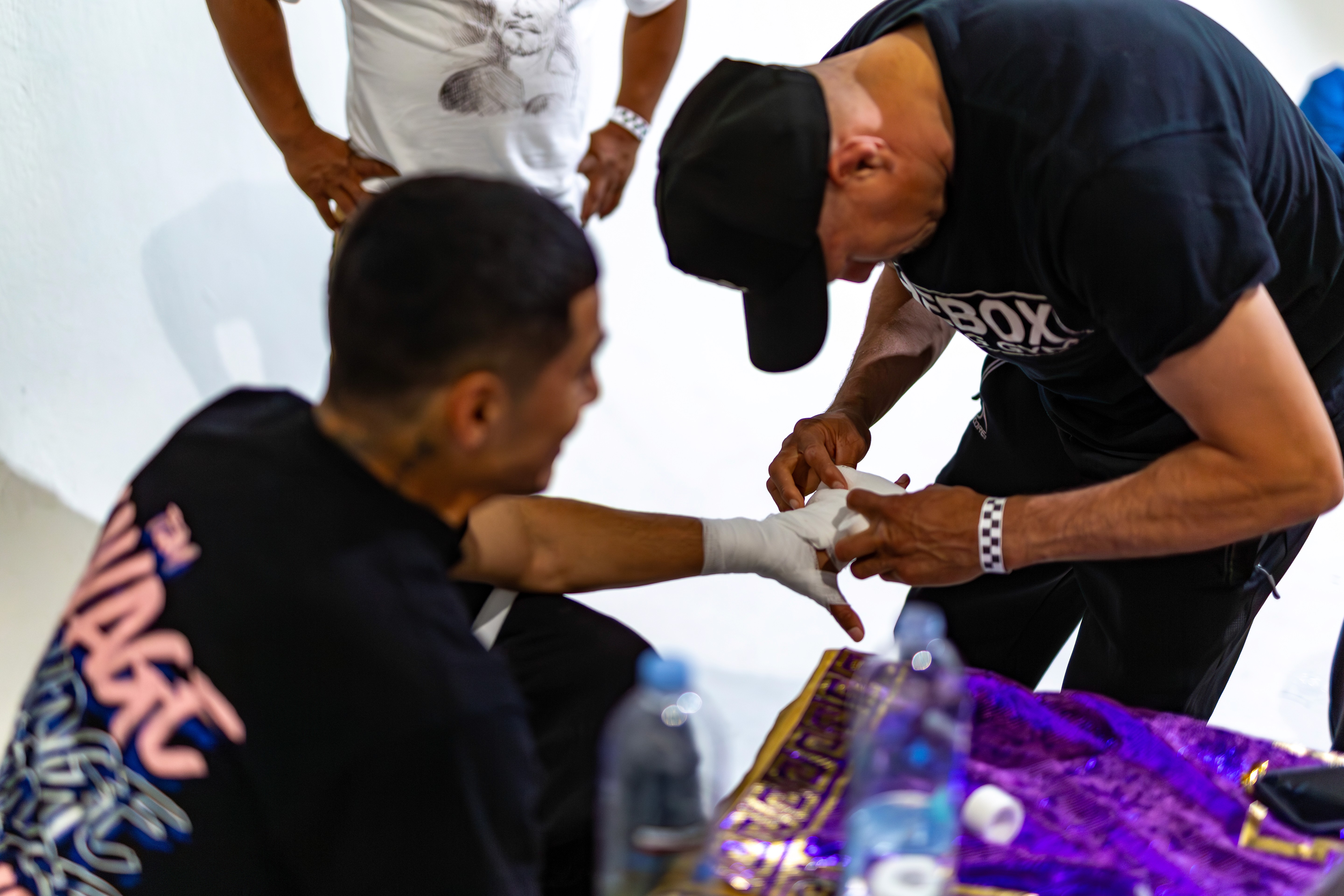 Jesus Soto Karass wrapping George "El Phantasma" Navarro's hands in the locker room before the fight. 