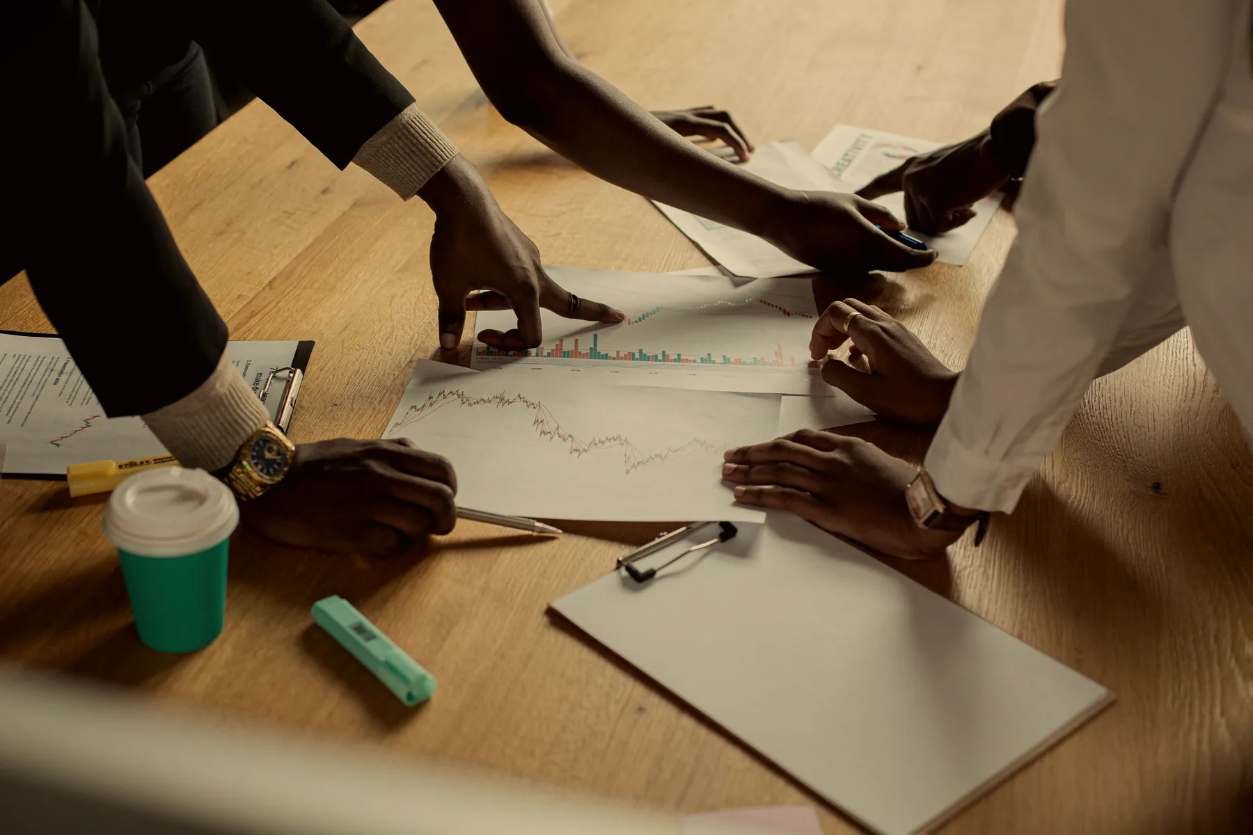 Team reviewing sales pipeline reports on a table