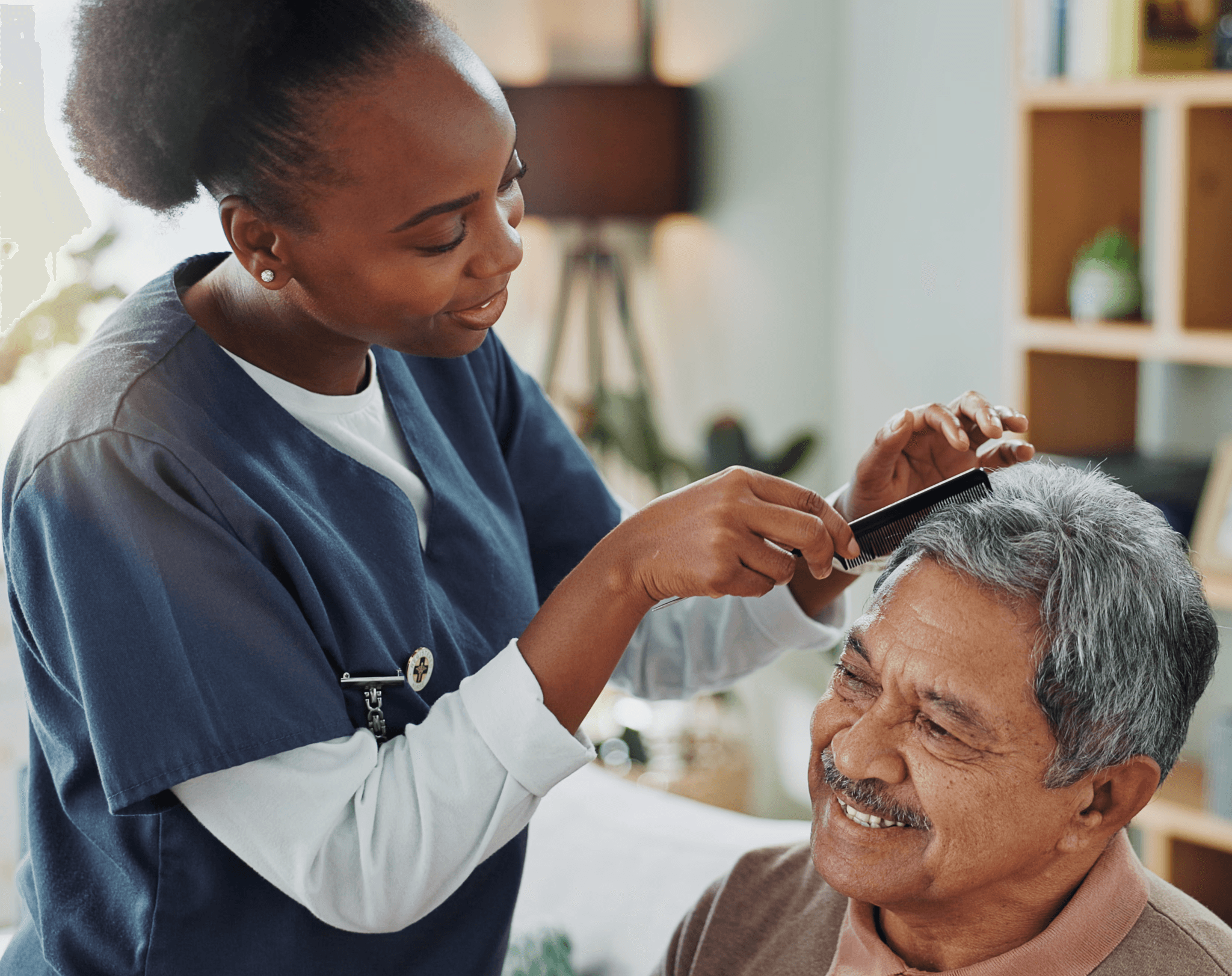 Caregiver helping a senior man with hair grooming. Example of Personal Senior Care offered by Age Easy.