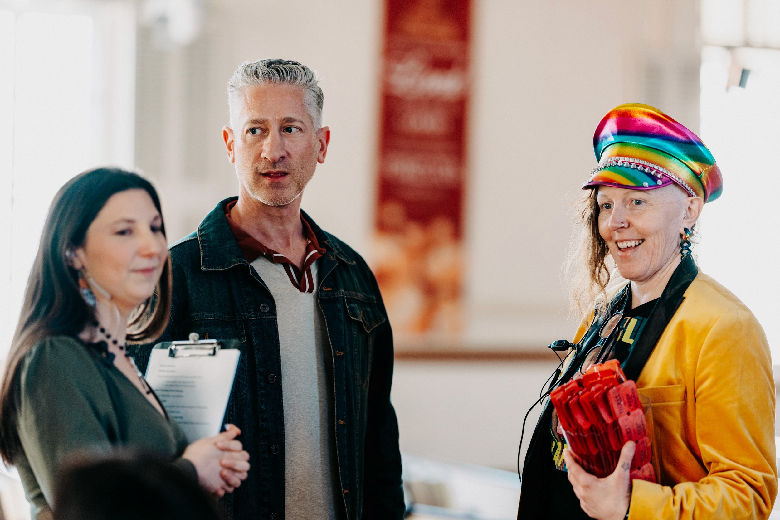 Attendees and organizer interacting during the Queer Open Mic (QOM) hosted by be; community in Bridgewater, Massachusetts