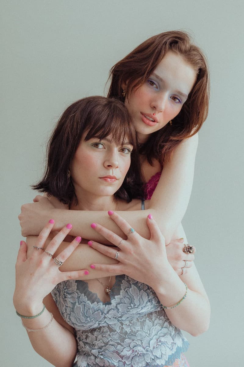 A close-up of two models embracing during a creative photoshoot at Revelator Studio, a natural light studio in Shreveport.