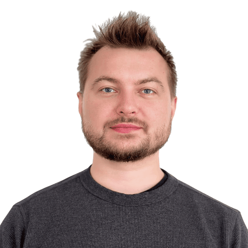 Profile portrait of a man in a white shirt against a light background