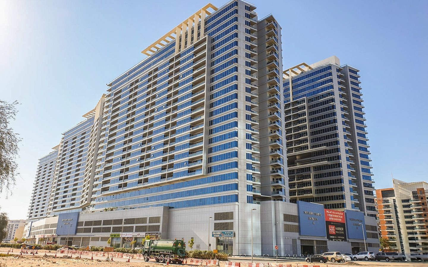 Modern exterior of Skycourt Towers Dubai, featuring high-rise luxury apartments for sale and rent in a prime location.