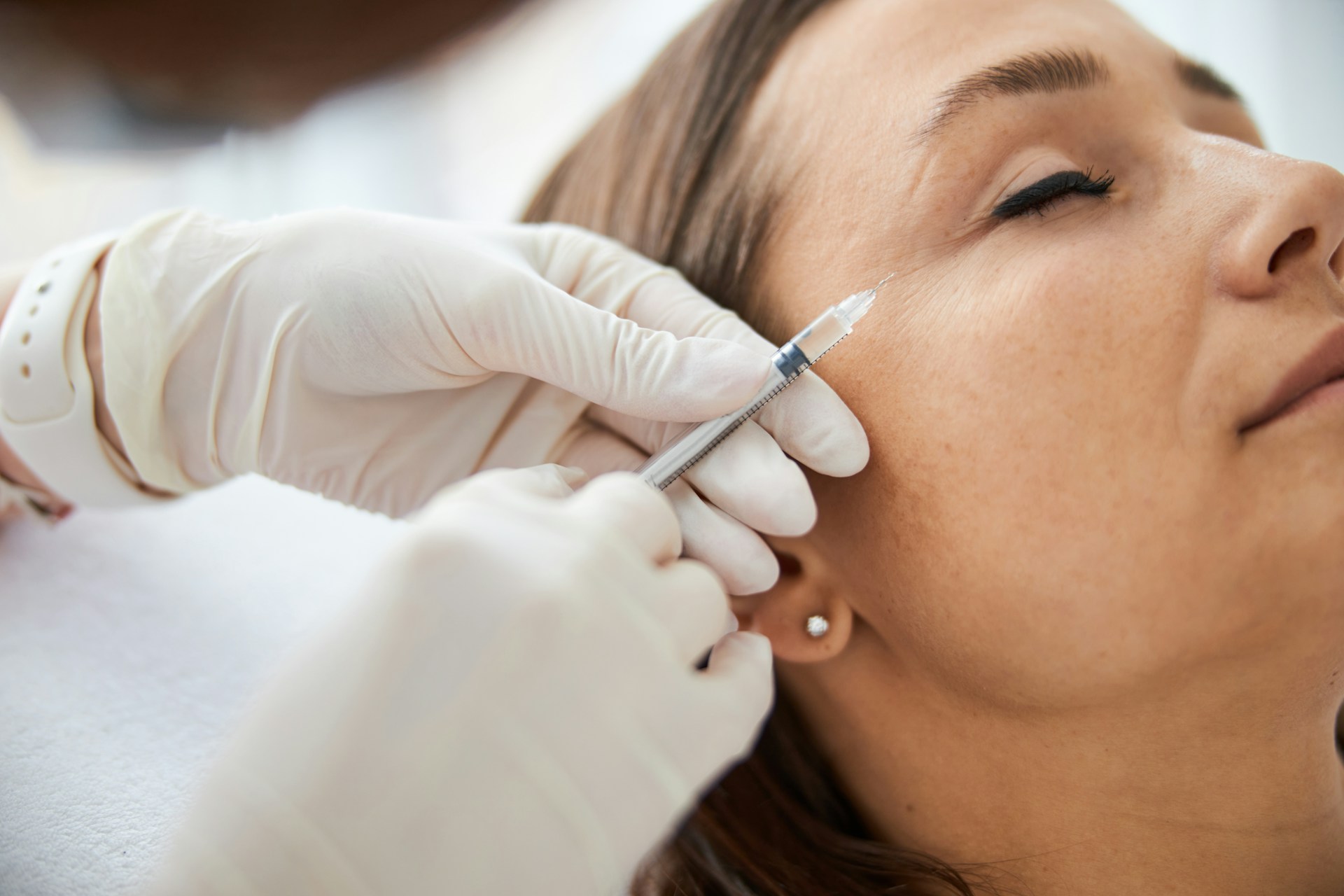 woman holding pen and white cotton candy