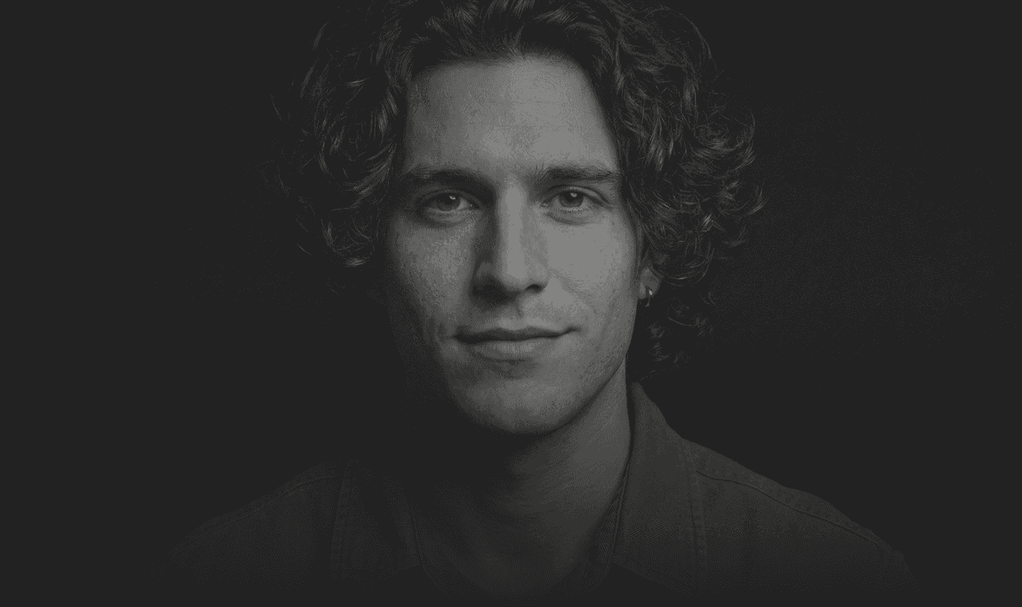 Moody hero header featuring a professional author portrait placeholder in the Blackwood Framer template.