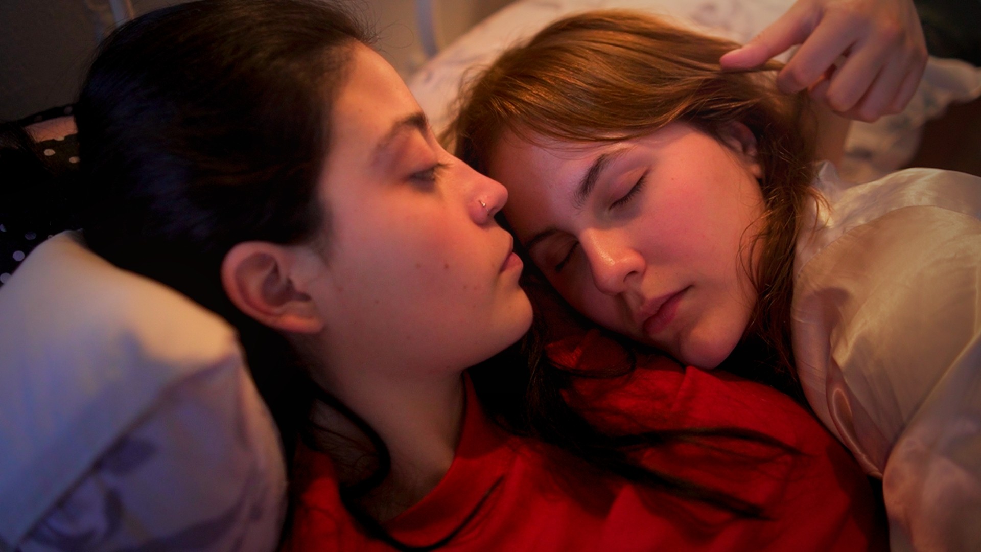View of the French countryside through a stone villa’s open living room, with sofas and trees framing the scene