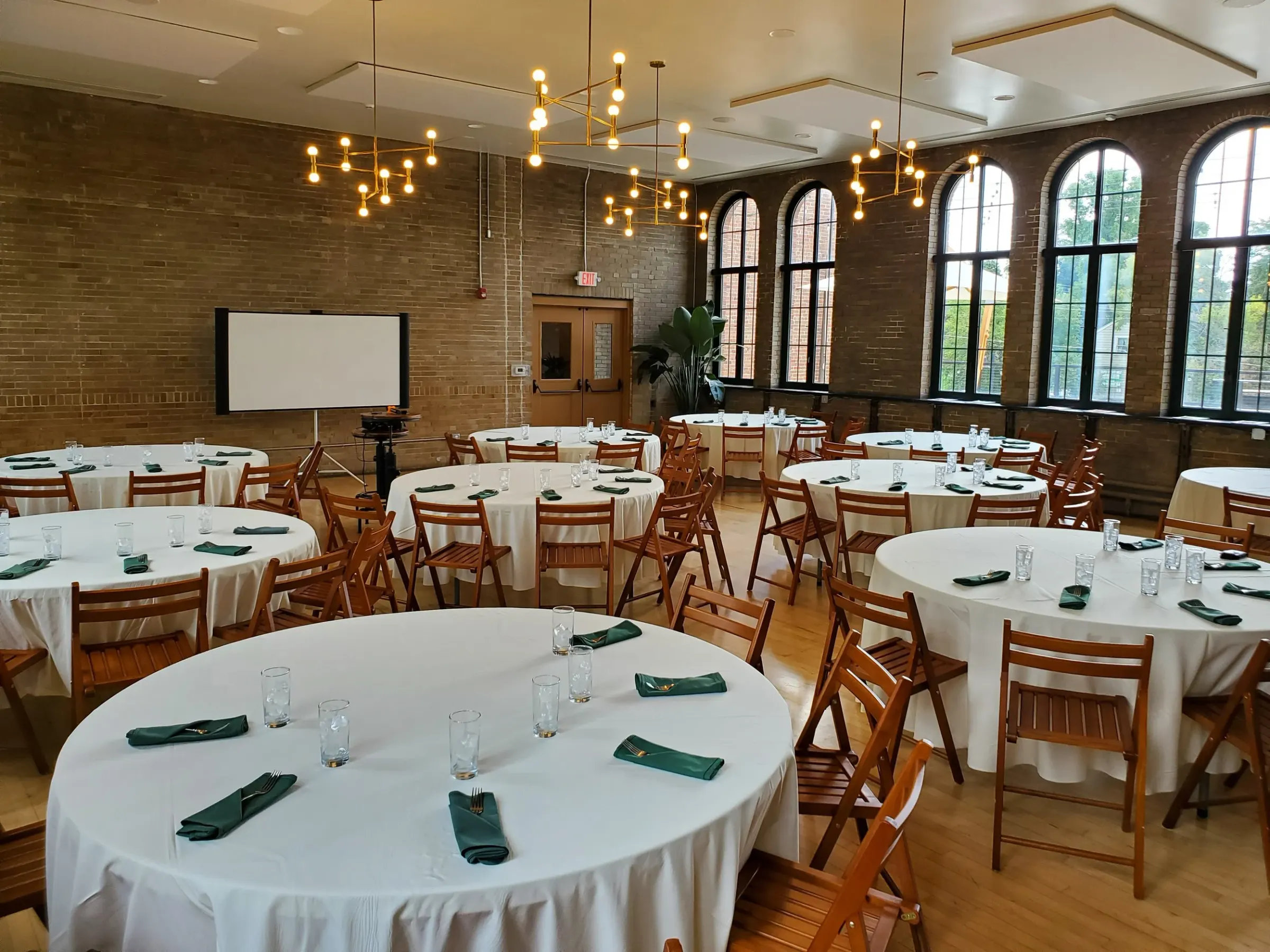 Fieldhouse set with round tables and chandeliers at Understory