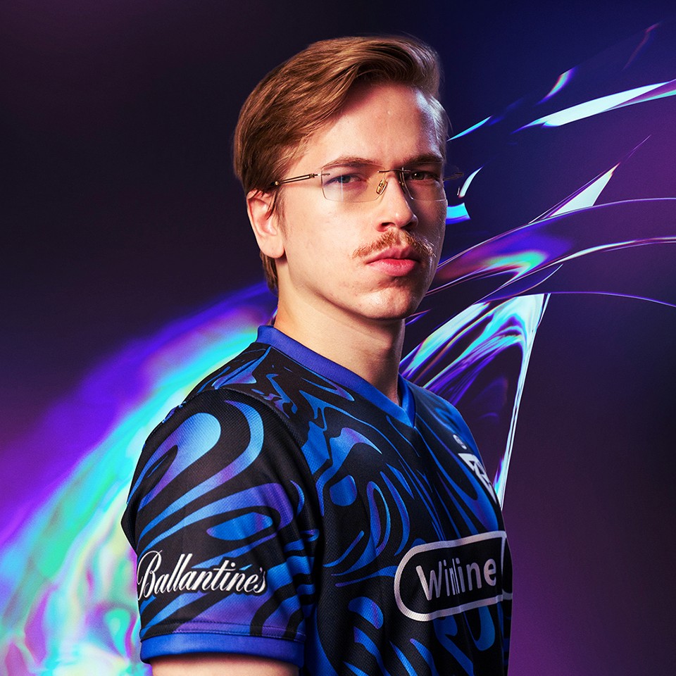 Portrait of a woman with straight long hair, in a dark t-shirt, set against a neutral backdrop.