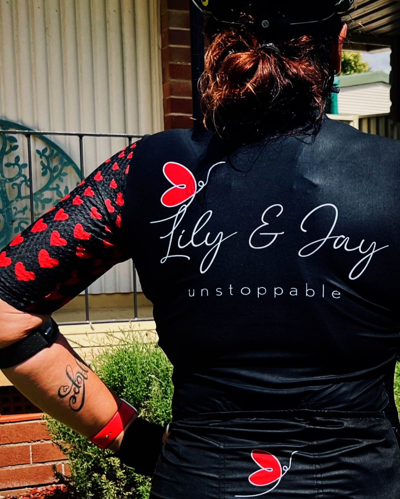 Image of the back of Lily's cycling jersey with personalised logo, Lily and Jay unstoppable, with butterfly motif