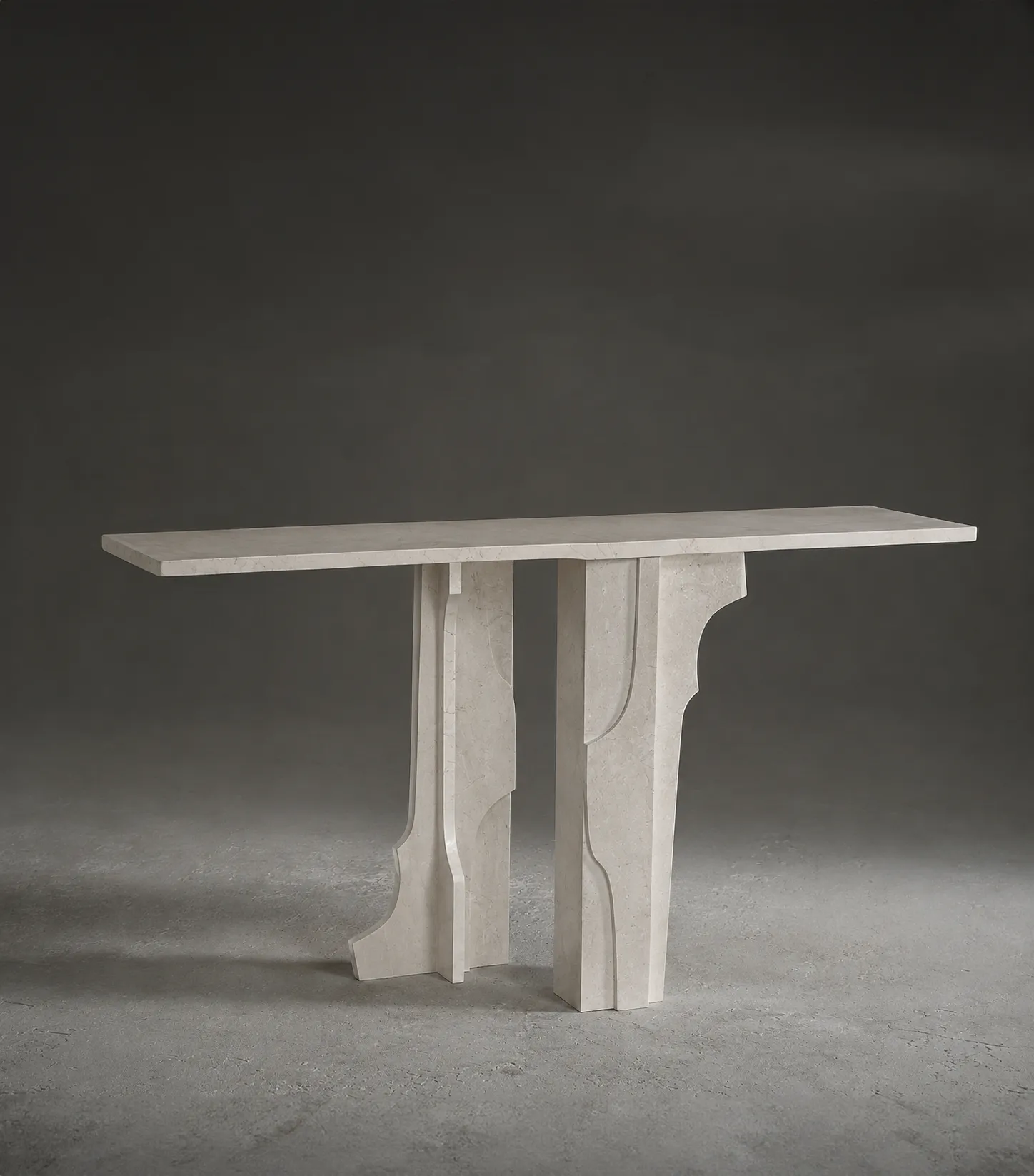 Studio view of the Peria sculptural marble console, featuring layered stone supports with curved architectural cut-outs.