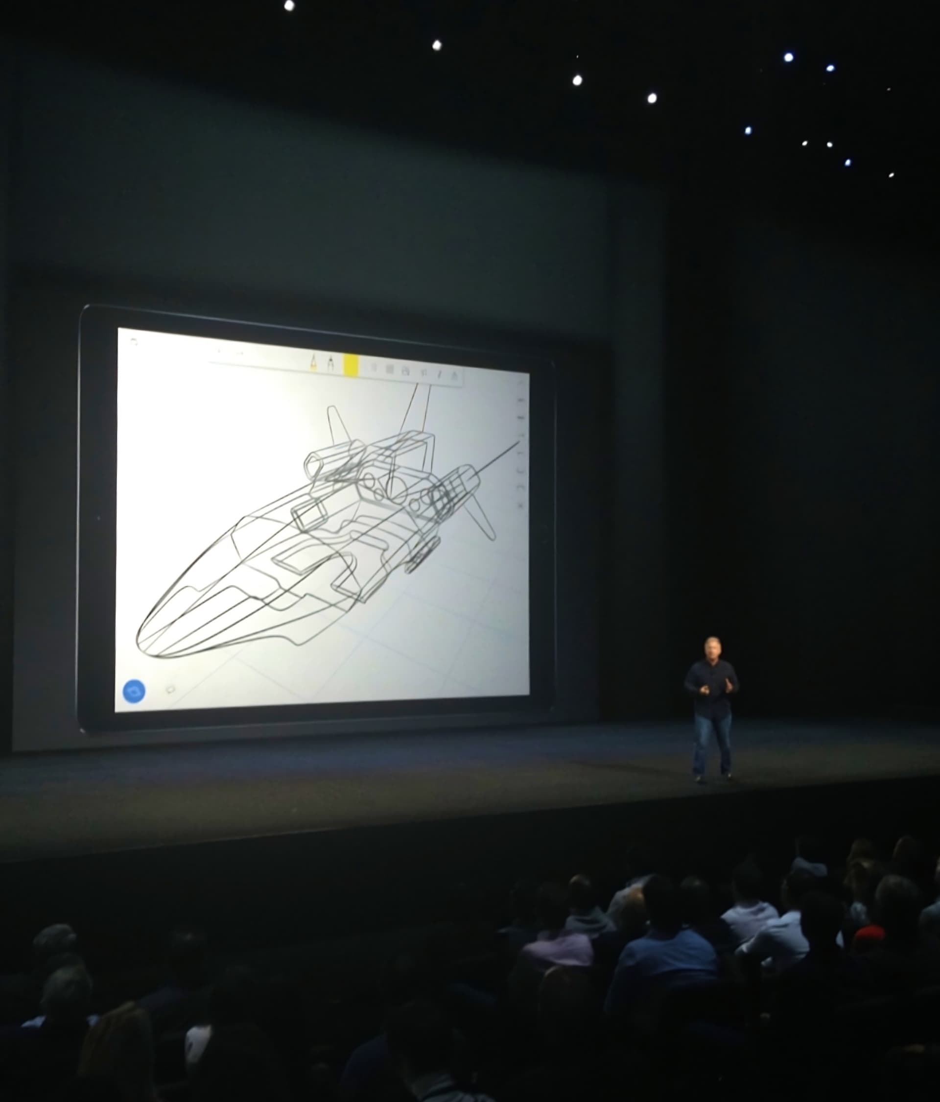 Phil Schiller stands on a stage in front of a large screen displaying a drawn design made in uMake at Apple's 2015 Keynote