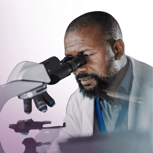 man looking in microscope