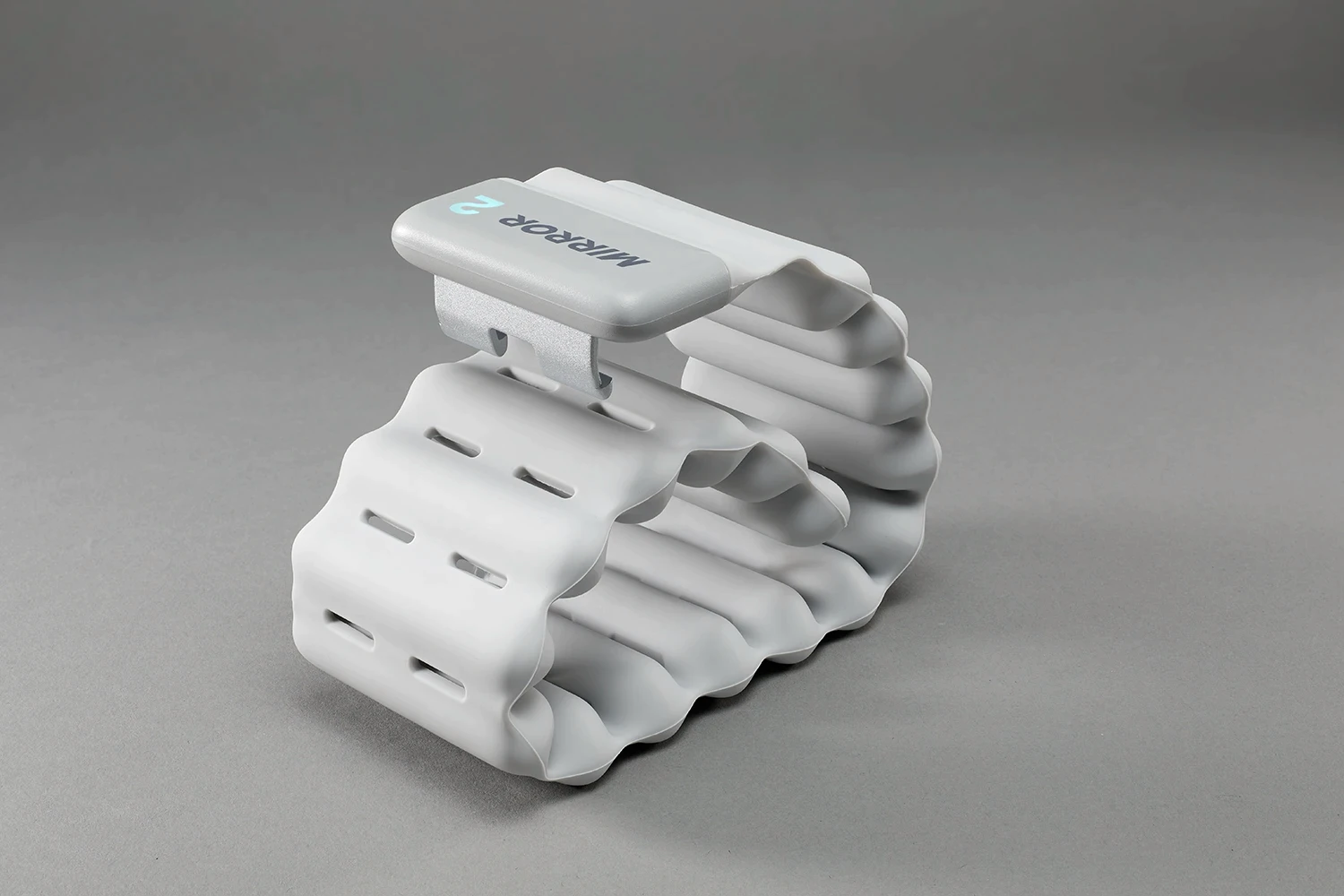 White Mirror connected ankle weight coiled into a compact loop